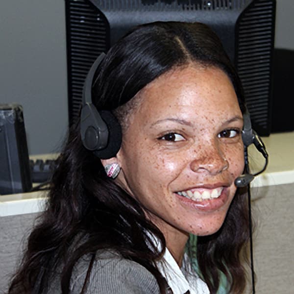 An SD&A caller wearing a headset at the national call center